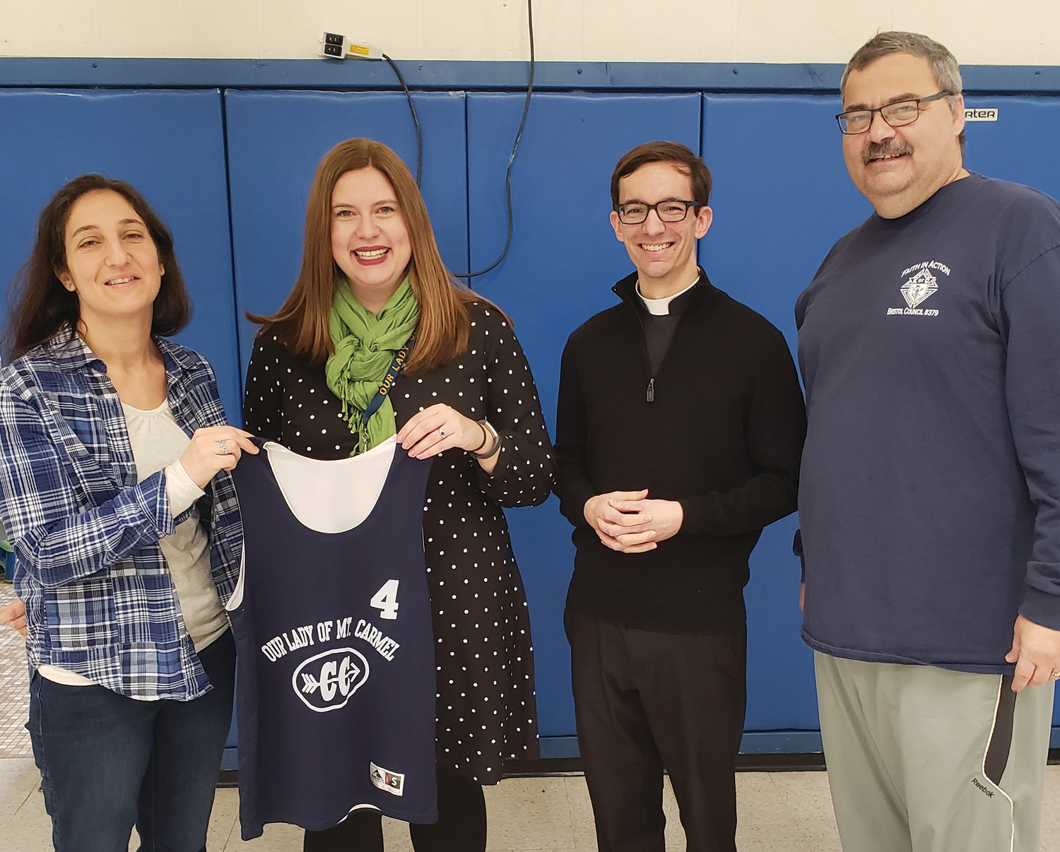 Knights of Columbus Council 379 recently organized a pasta dinner and raised the $900 needed to purchase new uniforms for Our Lady of Mount Carmel Cross Country team. Past Grand Knight Warren Rensehausen of Bristol Knights is pictured with cross country coach, Julie Torres, principal Jessica Walters and Father Steve Battey, assistant pastor.